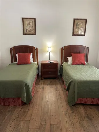 a bedroom with a bed and wooden floor