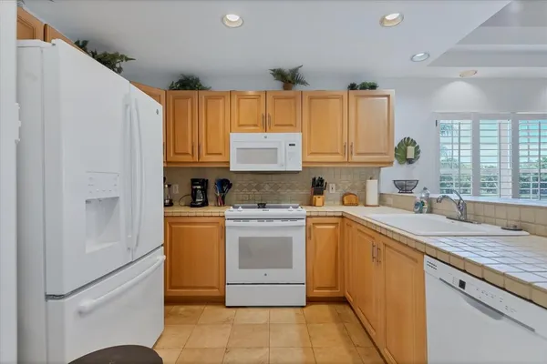a kitchen with a sink window and cabinets