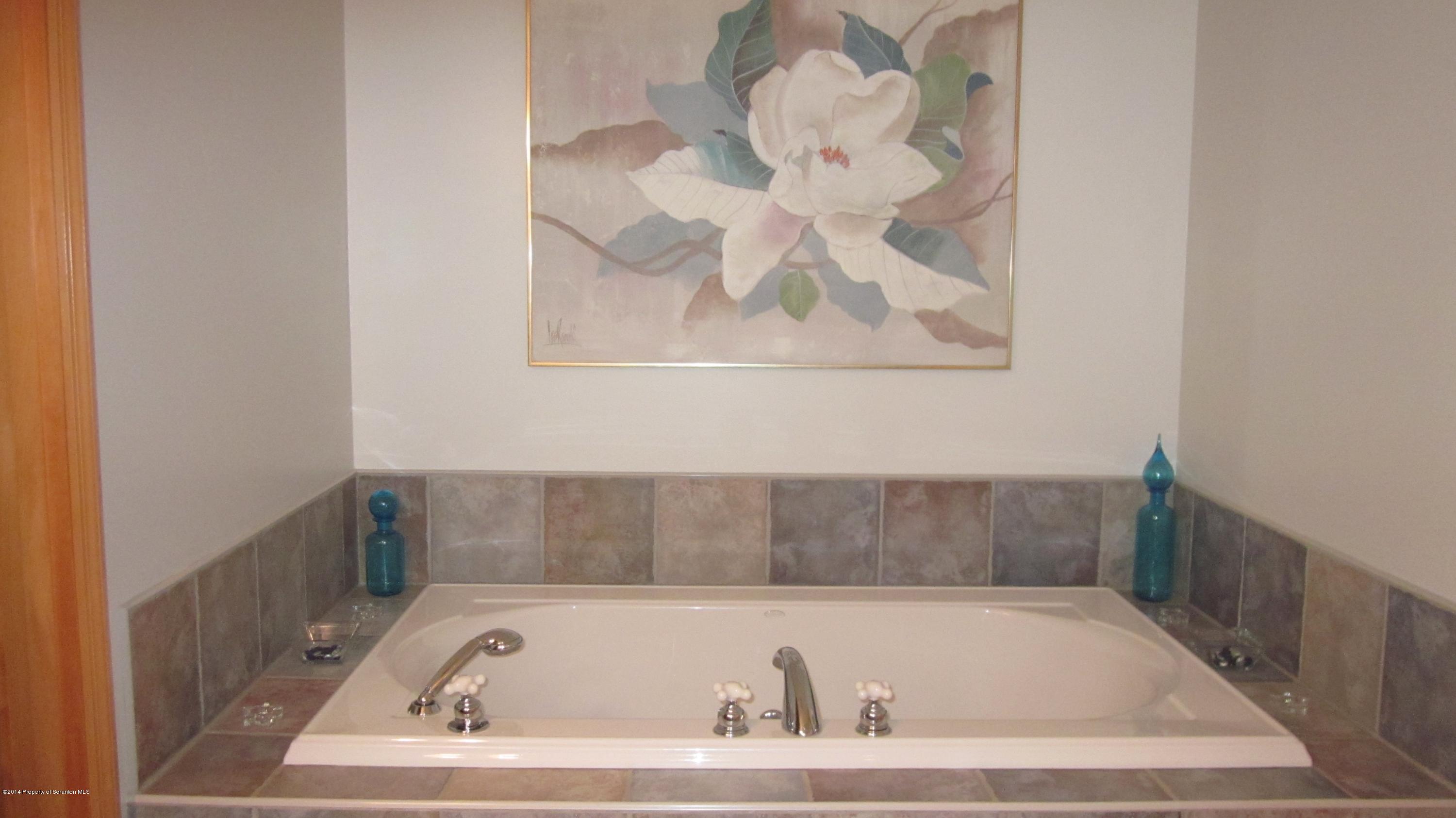 329 Golf Club Road Moscow, PA 18444 - Photo 26 of 56 a bathroom with a tub