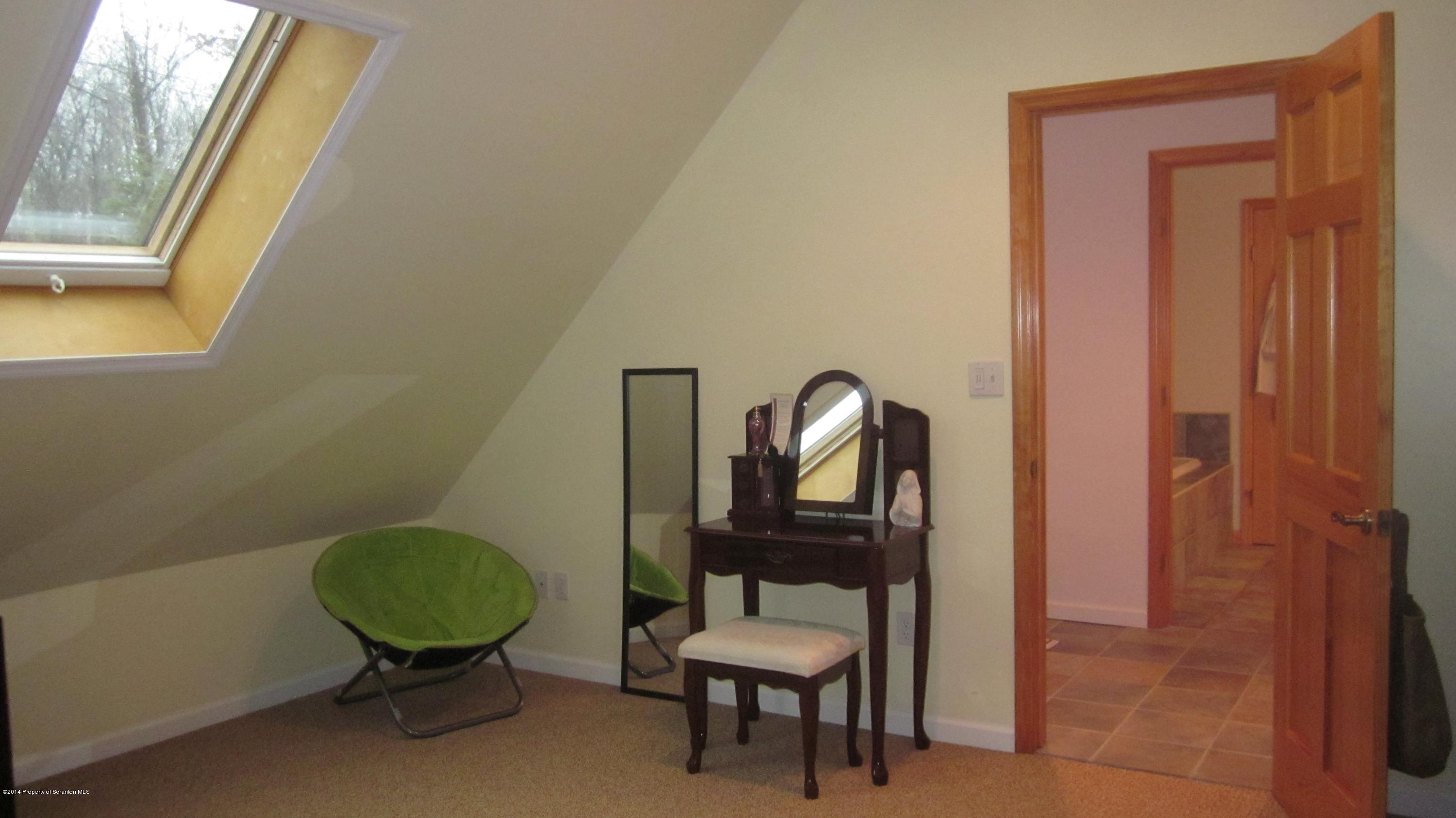 329 Golf Club Road Moscow, PA 18444 - Photo 29 of 56 a room with a chair and a mirror
