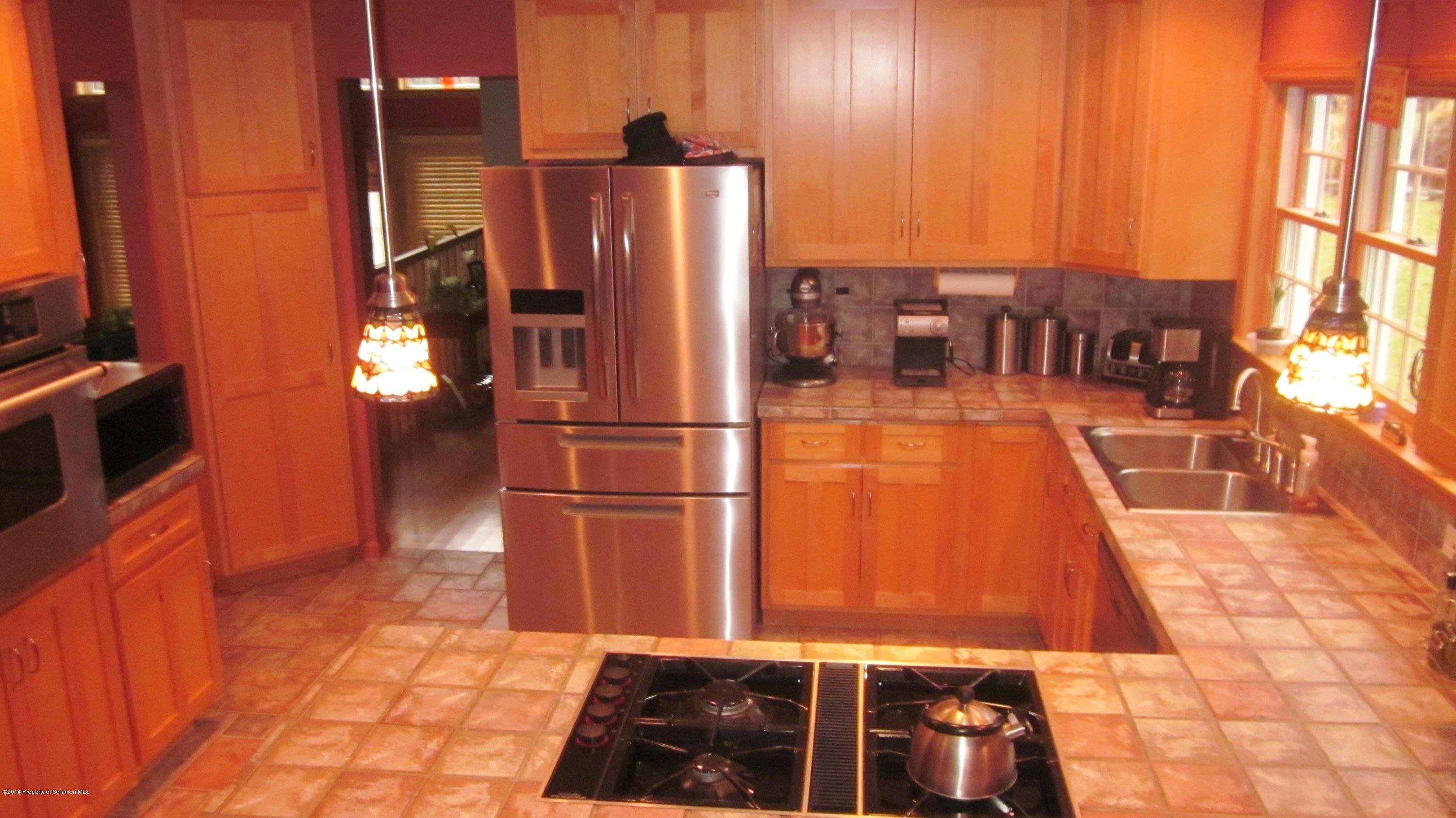 329 Golf Club Road Moscow, PA 18444 - Photo 4 of 56 a kitchen with stainless steel appliances granite countertop a refrigerator and a stove