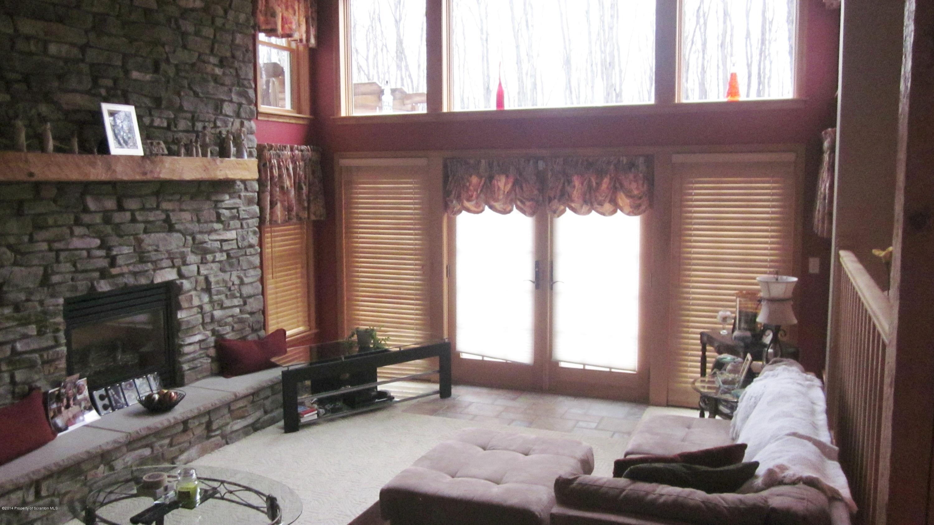 329 Golf Club Road Moscow, PA 18444 - Photo 9 of 56 a living room with furniture and a fireplace