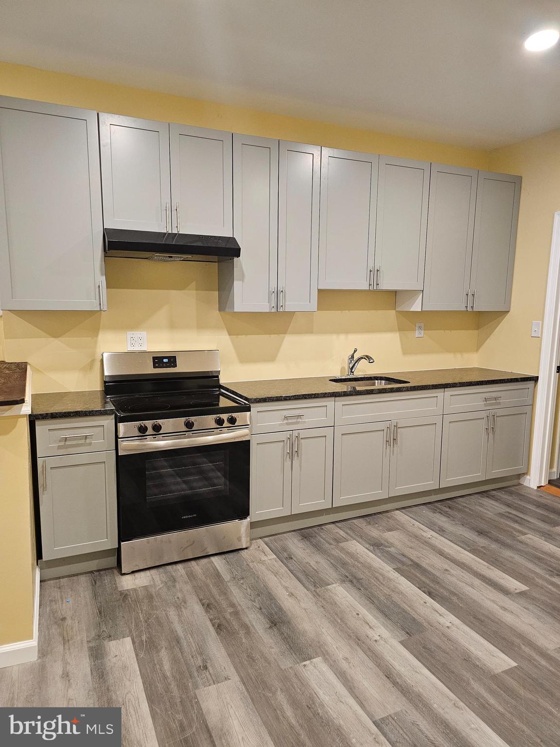 1535 North 60th Street, Unit A Philadelphia, PA 19151 - Photo 3 of 11 a kitchen with a sink stove and cabinets