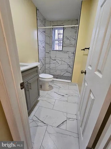 a bathroom with a toilet and a shower