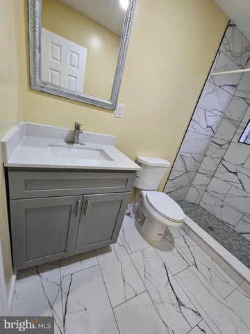 a bathroom with a sink toilet and mirror