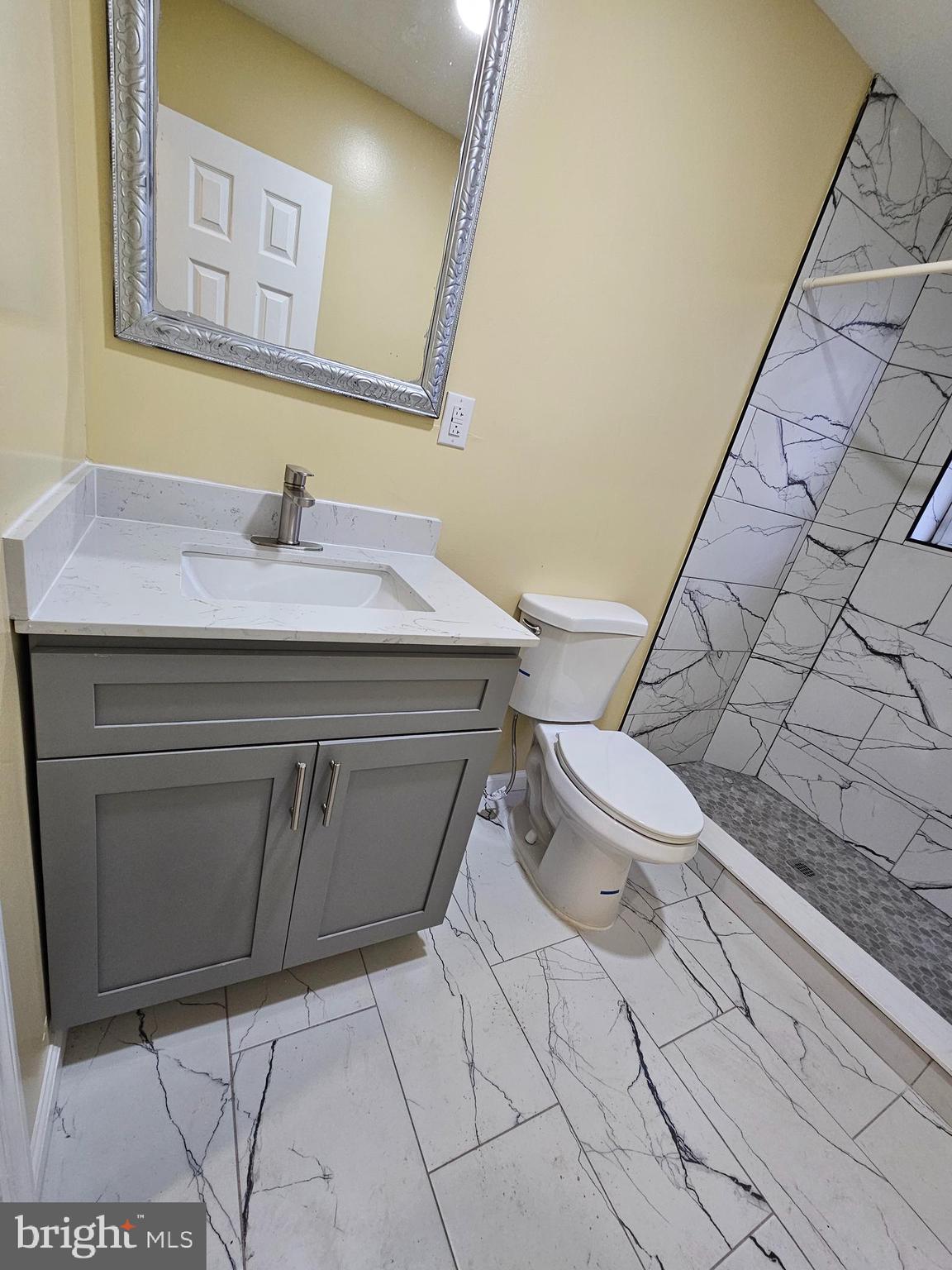 1535 North 60th Street, Unit A Philadelphia, PA 19151 - Photo 7 of 11 a bathroom with a sink toilet and mirror