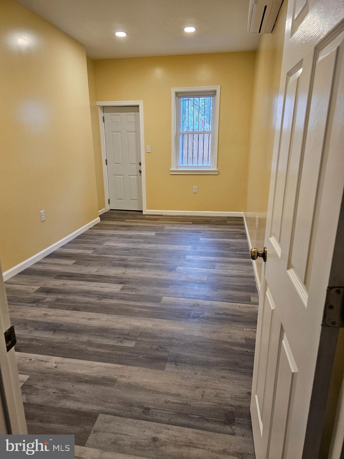 1535 North 60th Street, Unit A Philadelphia, PA 19151 - Photo 8 of 11 a view of an empty room with wooden floor and a window