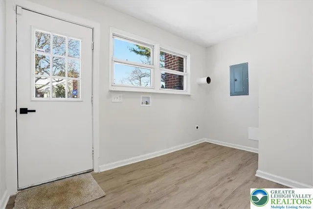 an empty room with wooden floor and window
