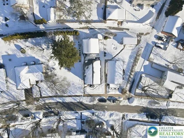 an aerial view of residential houses with city view