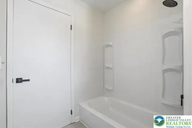 a white bath tub sitting next to a white sink