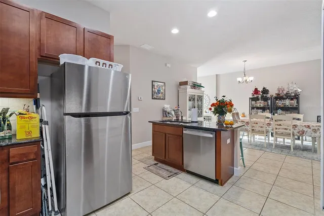 a kitchen with stainless steel appliances granite countertop a refrigerator and a sink