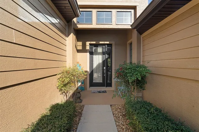 a couple of potted plants in front of door