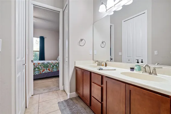 a en suite bathroom with a sink mirror and a bathtub