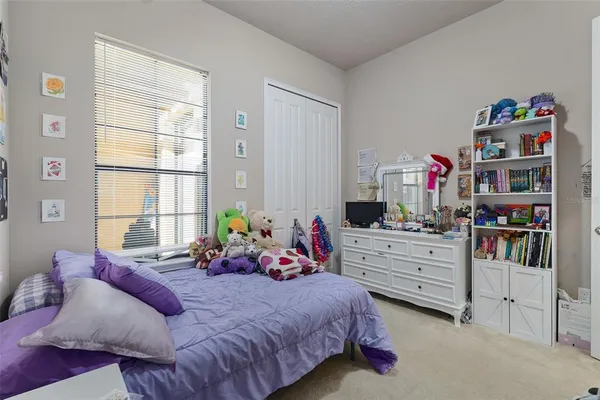 a bed room with bed and a window