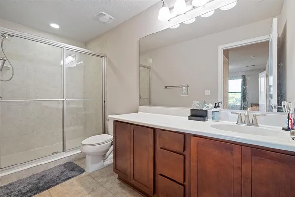 a bathroom with a double vanity sink mirror and toilet