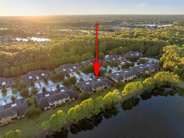 an aerial view of residential building and lake