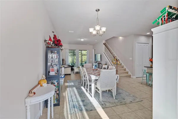 a view of a dining room with furniture and a chandelier