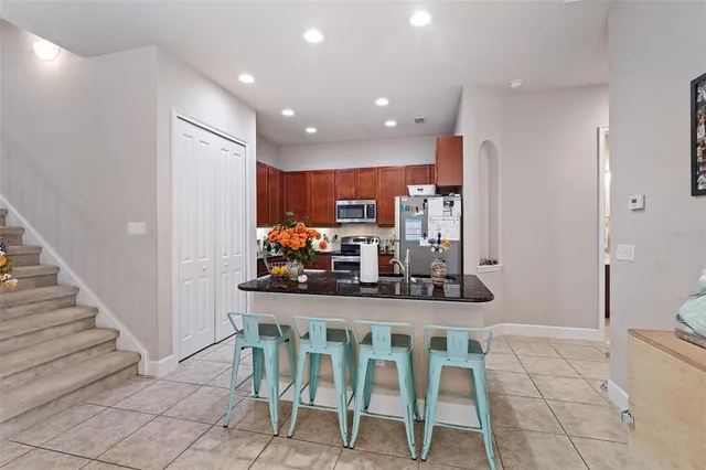 a dining room with furniture and a view of kitchen