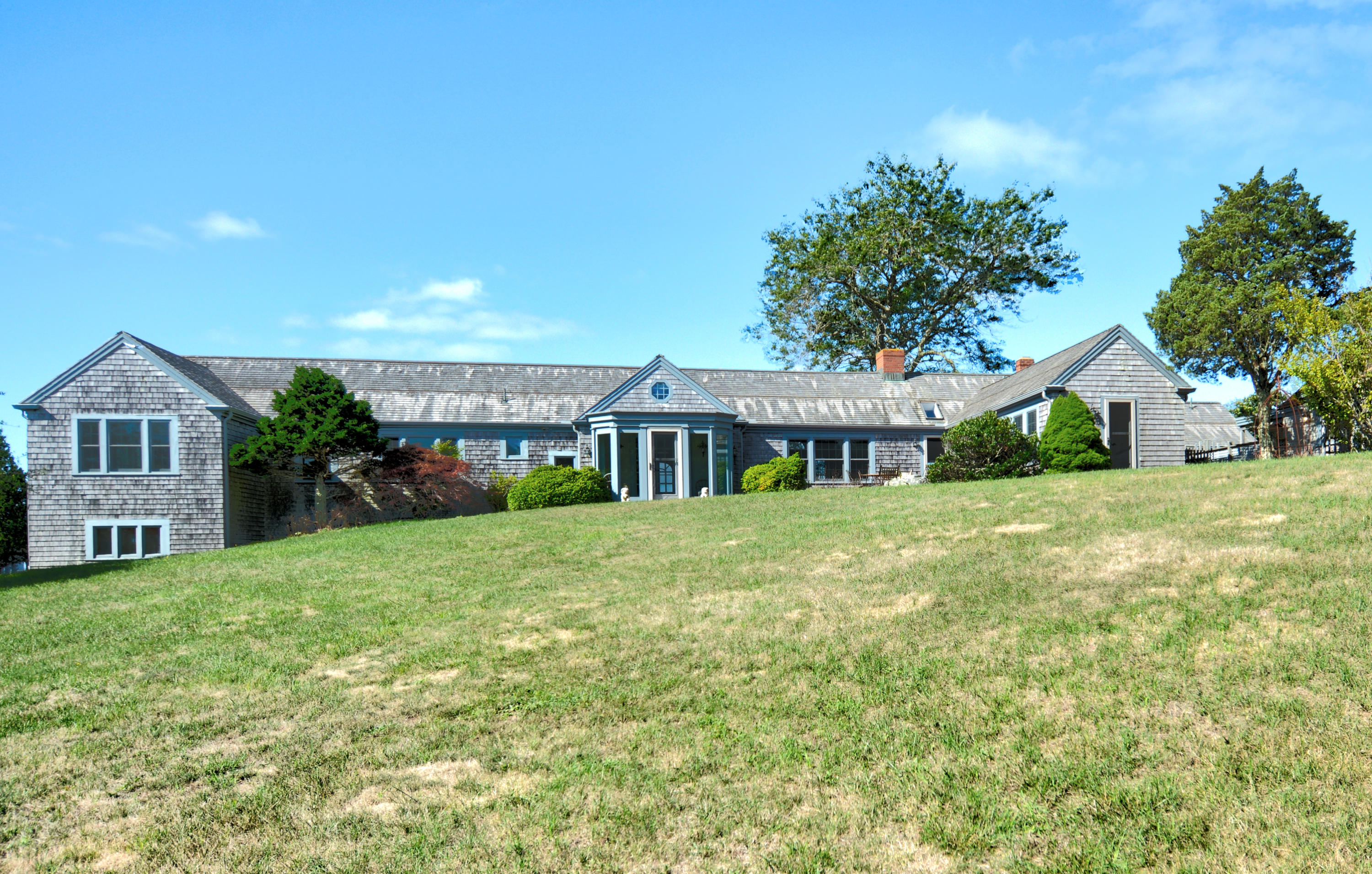 a front view of a house with a garden