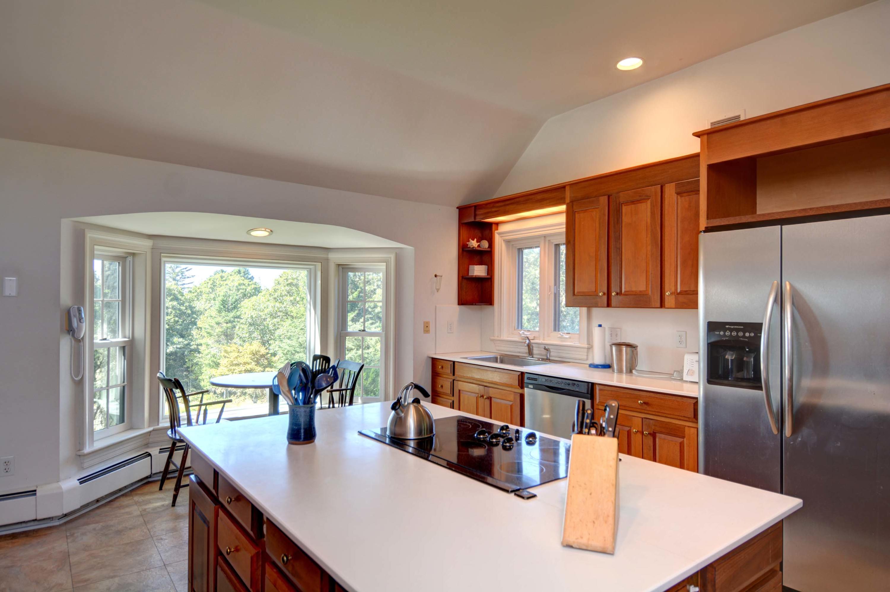 17 High Mark Road Chilmark, MA 02535 - Photo 21 of 52 a kitchen with kitchen island a large window cabinets and stainless steel appliances