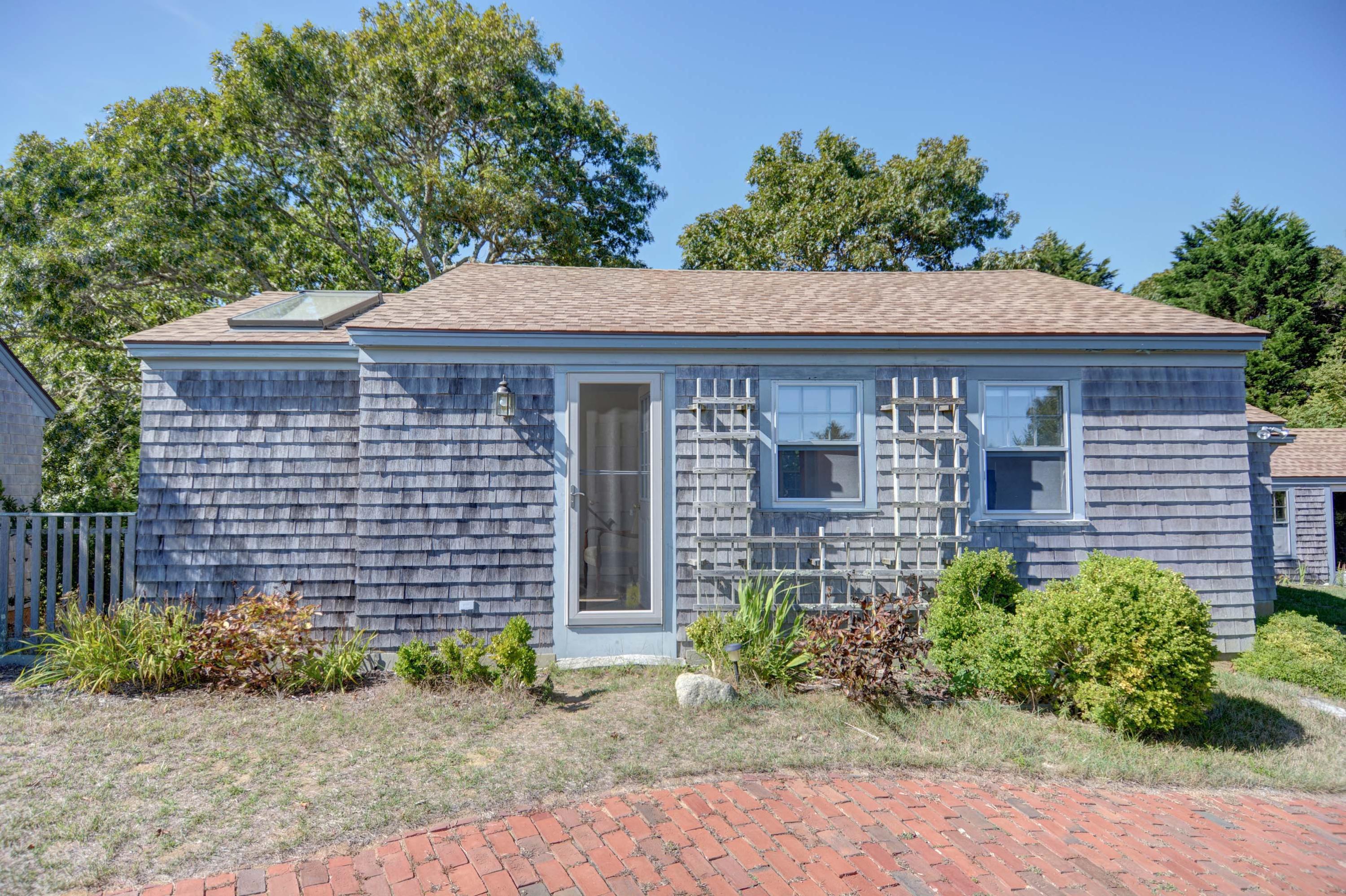 17 High Mark Road Chilmark, MA 02535 - Photo 37 of 52 a front view of a house with a yard