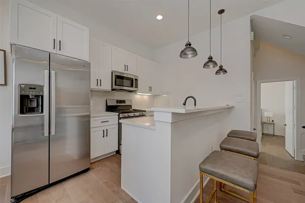 a kitchen with a refrigerator and a sink