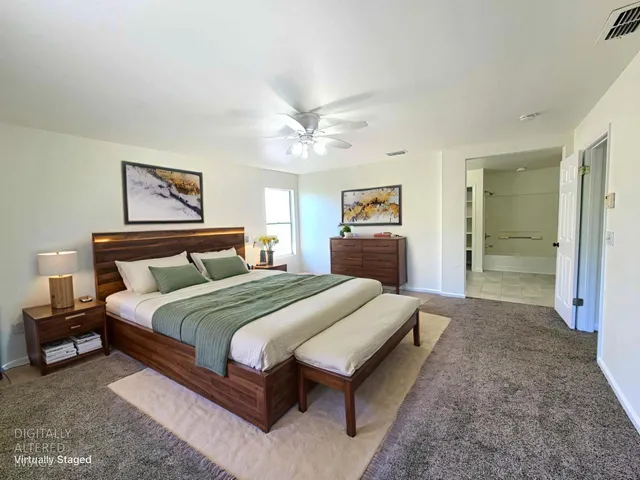 a spacious bedroom with a bed and a table