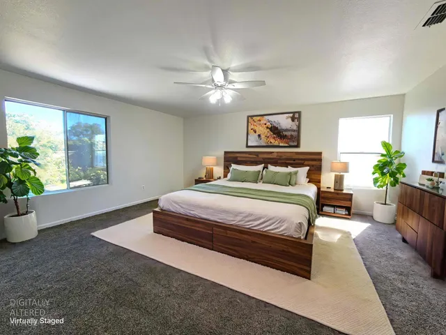 a bedroom with a large bed and a window