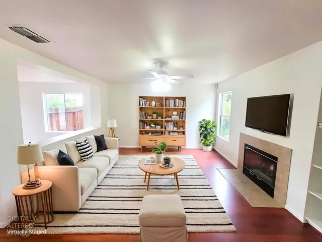 a living room with furniture a fireplace and a flat screen tv