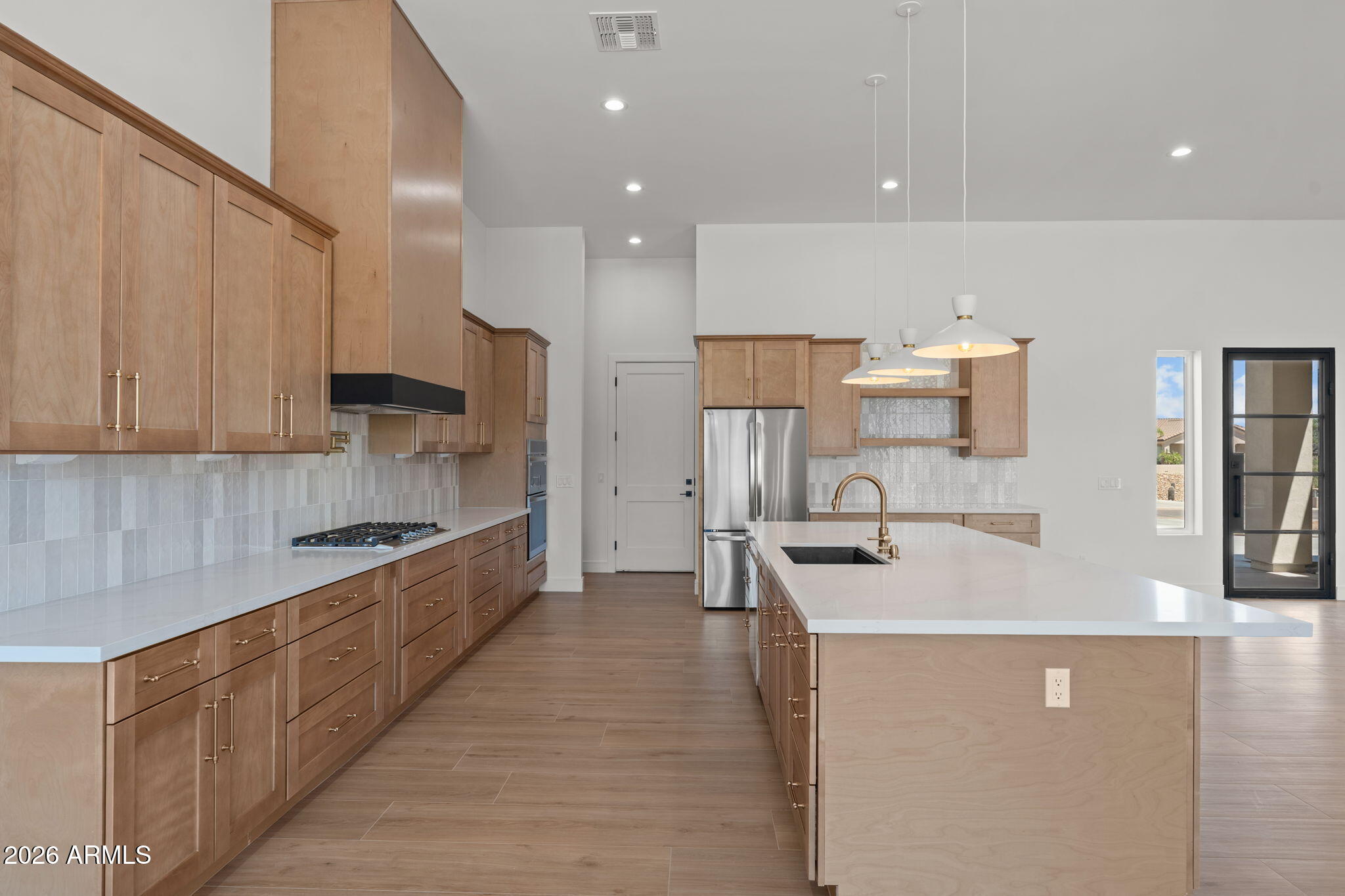 2855 Percheron Road Wickenburg, AZ 85390 - Photo 22 of 58 a kitchen with stainless steel appliances a refrigerator sink and cabinets