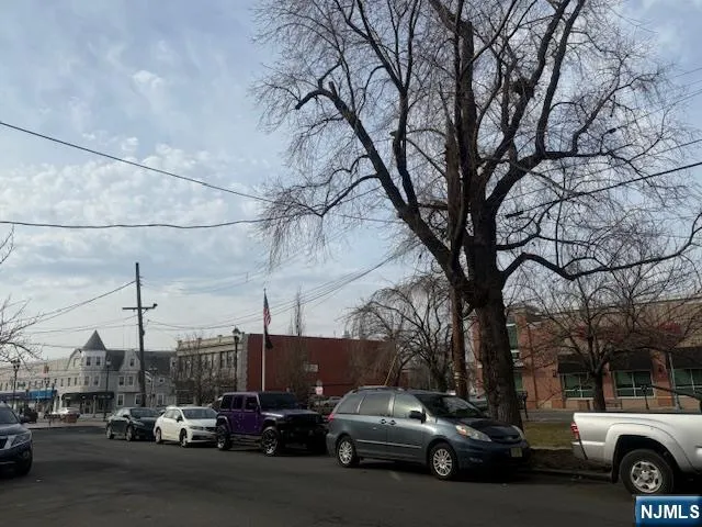 a view of a city street with a car parked on the road