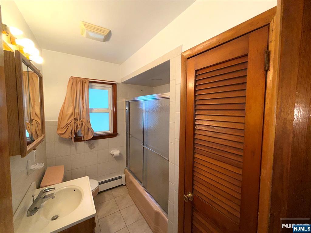 20 Beech Street, Unit 2 Kearny, NJ 07032 - Photo 4 of 13 a bathroom with a sink and mirror