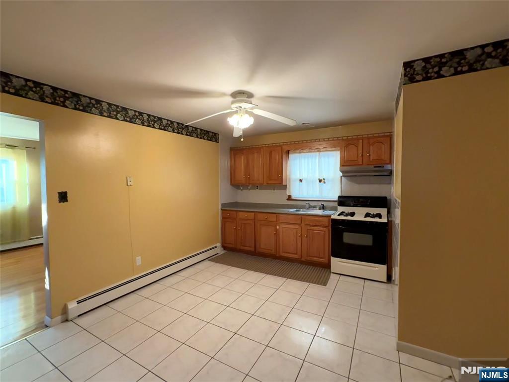20 Beech Street, Unit 2 Kearny, NJ 07032 - Photo 7 of 13 a kitchen with stainless steel appliances a refrigerator and a stove top oven