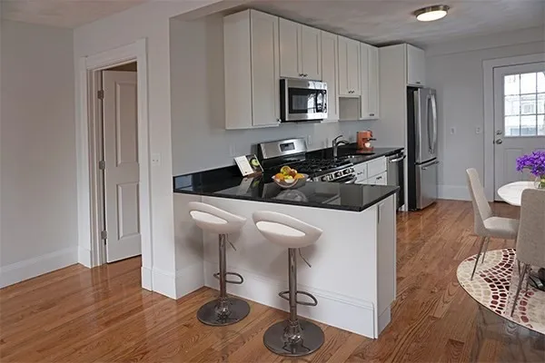 a kitchen with a sink appliances and cabinets