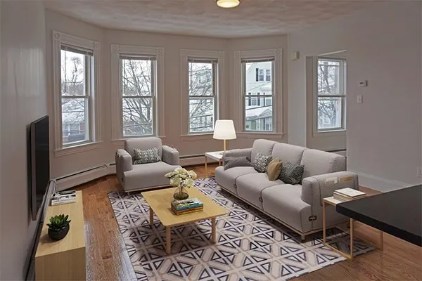 a living room with furniture rug and window