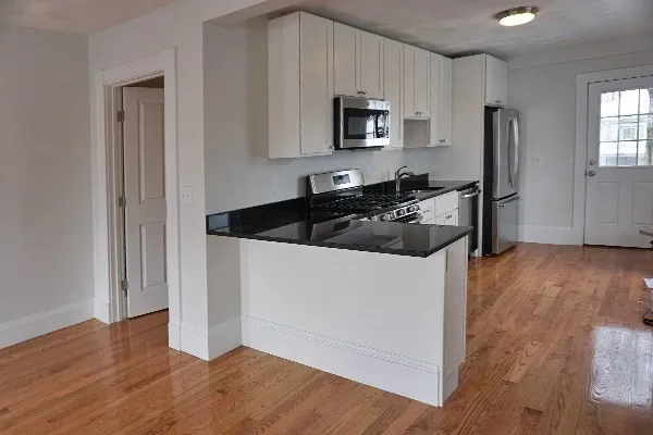 a kitchen with a refrigerator stove and microwave