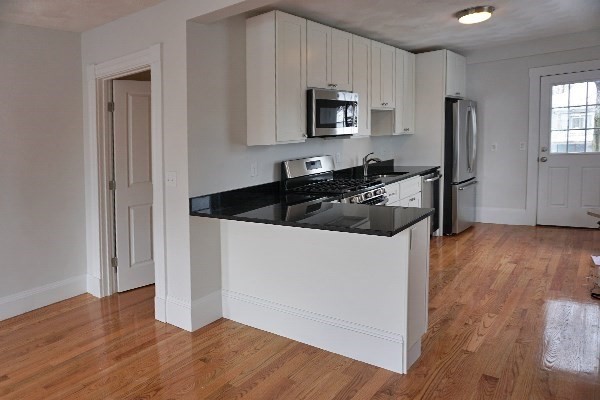 252 Ash Street, Unit 4 Waltham, MA 02453 - Photo 7 of 13 a kitchen with a refrigerator stove and microwave