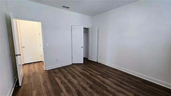 a bathroom with a granite countertop sink a toilet and bathtub
