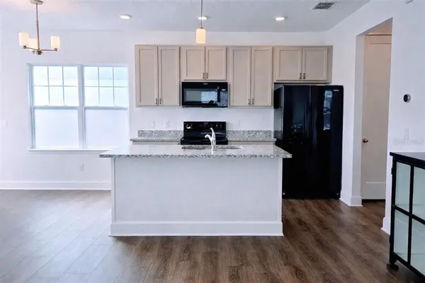 a view of kitchen island with furniture and wooden floor
