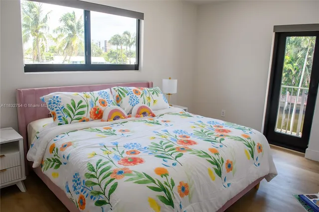 a front view of a house with a yard and potted plants