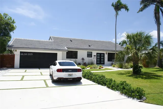 a bedroom with a bed and large window