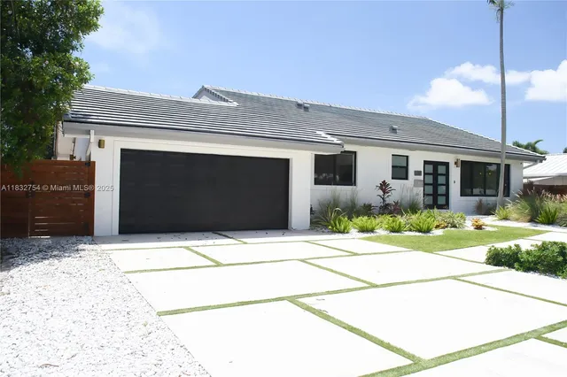 a bedroom with a bed and a lamp on dresser