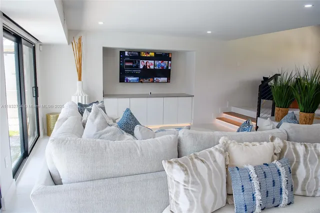 a living room with furniture and a flat screen tv