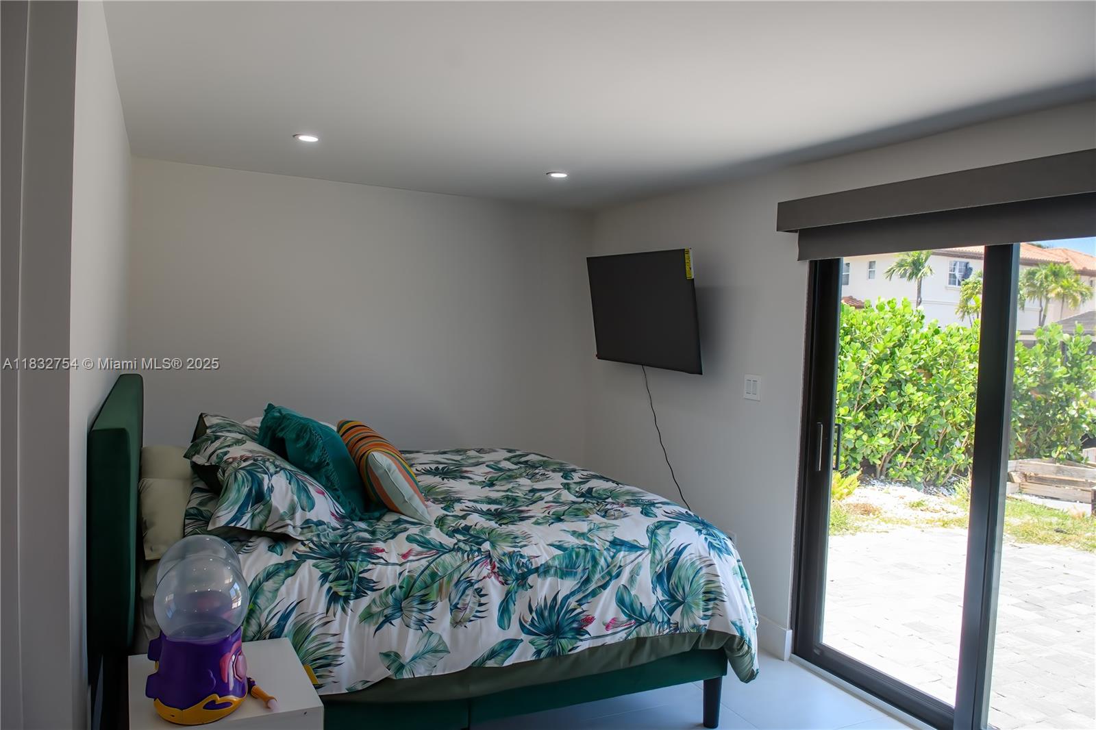 1240 Northeast 27th Terrace Pompano Beach, FL 33062 - Photo 31 of 98 a bedroom with a bed and large window