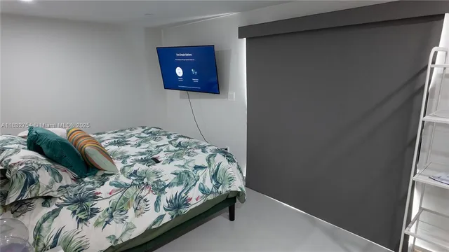 a bedroom with a bed a dresser and a mirror