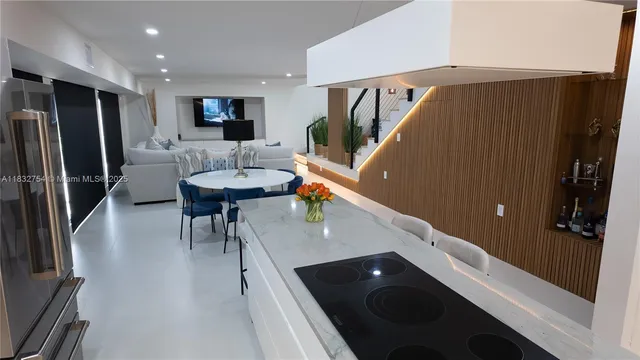 a living room with furniture and a floor to ceiling window