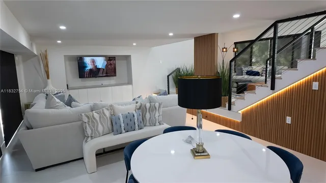 a living room with furniture and a potted plant