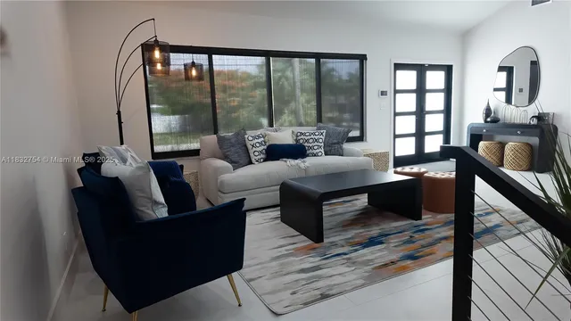 a living room with furniture and a large mirror