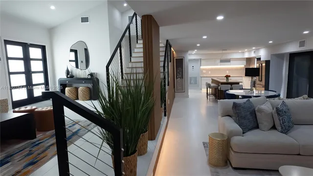 a living room with furniture and a potted plant