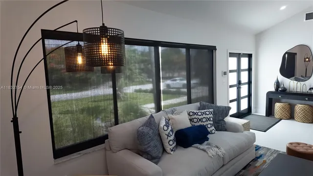 a living room with furniture and a large window